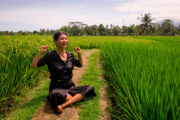 outdoors yoga and meditation at rice field - attractive and happy middle aged Asian Korean woman enjoying yoga and relaxation in connection with the nature