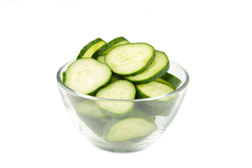 Fresh cucumber slices in bowl isolated on white background.