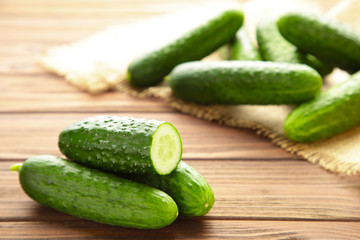 Fresh cucumber slices on brown wooden background.
