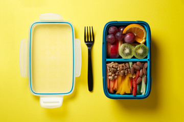 Top View of Full Lunch Box with Fuits, Vegetables and nuts.
