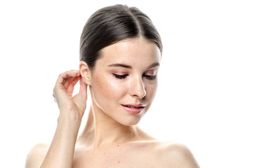 Fototapeta premium a close-up portrait of a young girl with clear skin. Isolated on a white background