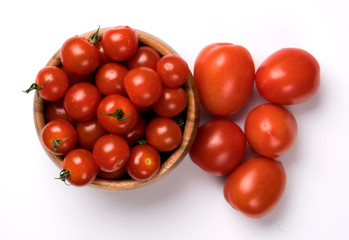 Wooden round bowl with ripe red tomatoes isolated on white background.