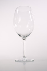 glass goblet close-up on a white - gray background, leg from the tank, a glass for wine,
