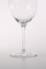 glass goblet close-up on a white - gray background, leg from the tank, a glass for wine,