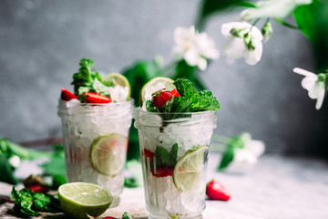 Mojito cocktail with strawberries, mint and lime. Lemonade