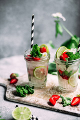 Mojito cocktail with strawberries, mint and lime. Lemonade