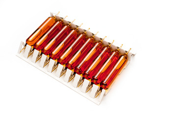 Packing of glass ampoules with a medical preparation shot on a white background.