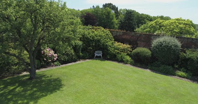 Beautiful chair in the corner of well kept garden