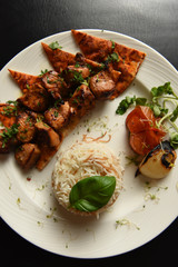 Kebabs served with vegetables and rice