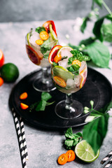 Lemonade with orange, lime, kumquat and mint in a glass
