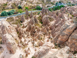 Aerial view of Goreme National Park, Goreme Tarihi Milli Parki, Turkey. The typical rock formations of Cappadocia with fairy chimneys and desert landscape. Travel destinations, holidays and adventure