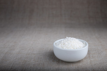 Coconut flakes in a bowl on the table