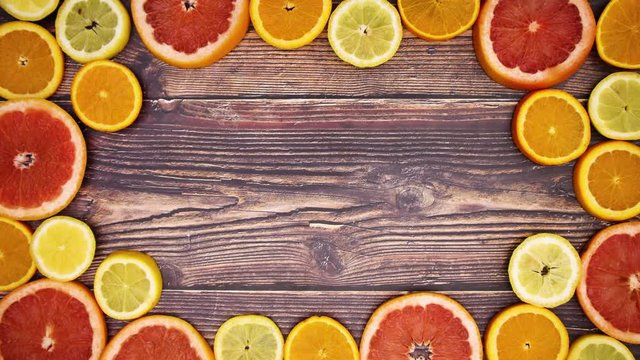 Slices of citrus fruits making border for your text - Stop motion 