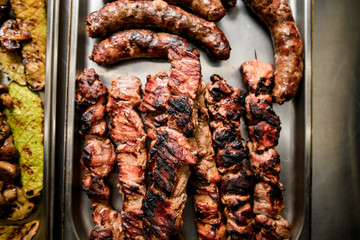 Fototapeta premium Top view on grilled pieces of meat cooked on barbecue.