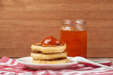 pancakes with apricot jam on a wooden background. Food for Breakfast in the morning. recipe for pancakes. selective focus and copy space. home cooking recipe
