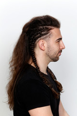 Stylish male model with braids posing in studio. Style, hairstyle, fashion concept.