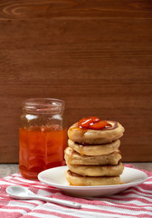 pancakes with apricot jam on a wooden background. Food for Breakfast in the morning. recipe for pancakes. selective focus and copy space. home cooking recipe