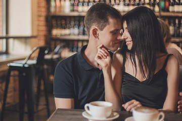 Loving couple hugging in the cafe.