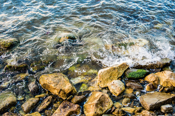 Sea ​​waves beating against rocks (stones)