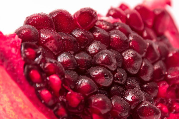 a slice of pomegranate on white background
