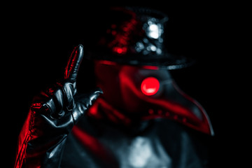 Plague doctor with crow-like mask disapproving with no finger sign, make negation gesture. Denying,...