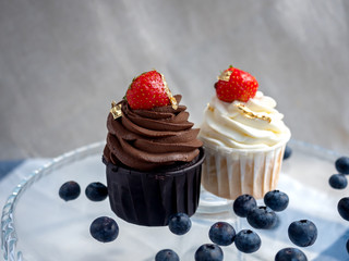 cream cake with berries. Chocolate and cream cake on a stand