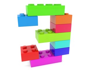 Number 3 from toy bricks of different colors on a white background