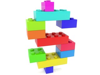 Dollar sign made of toy bricks of different colors on a white background