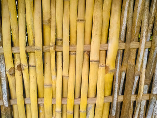 Bamboo dry sheet curtain tied with light wood tone background. Texture