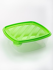 transparent food storage container with green lid