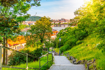 View of Prague from Vysehrad with bridges over Vltava river, Prague castle in the background in the evening and a lantern in the foreground. Prague. Czech Republic.