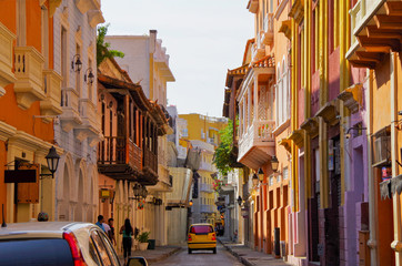 Walking the narrow and colorful streets with historic old buildings with wooden balconies and urban...