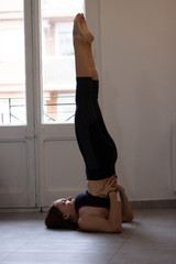 Sporty young woman doing yoga in home - concept of healthy life and natural balance between body...