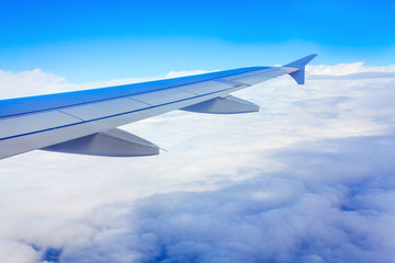 airplane wing above the clouds during the flight