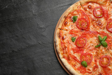 Delicious pizza Margherita on dark grey table, top view. Space for text