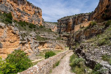 Fototapeta na wymiar The Our Lady of Jaraba Sanctuary in the Barranco de la Hoz Seca canyon (Dry Defile Gully) in the Aragon region, Spain, during a sunny summer day