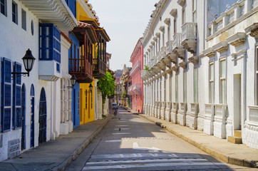 Walking the narrow and colorful streets with historic old buildings with wooden balconies and urban...