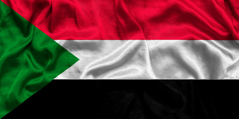 National flag of Sudan background with fabric texture. Flag of Sudan in correct proportions waving in the wind. 3D illustration