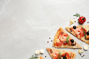 Tasty pizza with seafood and ingredients on light grey marble table, flat lay. Space for text