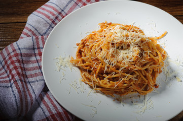 Spaghetti Bolognese with Parmesan cheese on the table, side view