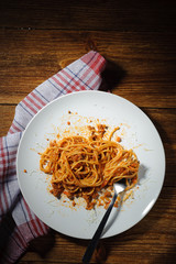 Spaghetti Bolognese with Parmesan cheese on the table, top view