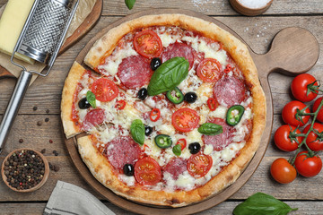 Delicious pizza Diablo on wooden table, flat lay