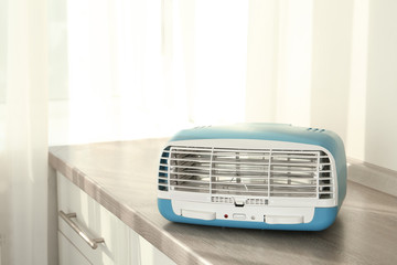 Stylish ionic air purifier indoors. Modern interior element