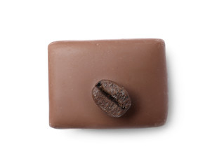 Delicious milk chocolate candy with coffee bean isolated on white, top view