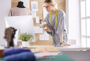 Fashion designer woman sewing with sewing machine