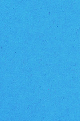 The surface of a sheet of blue or azure cardboard. Rough natural paper texture with cellulose...