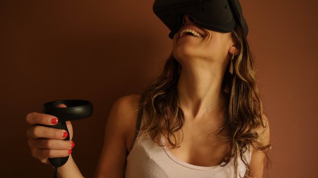 Woman wearing 3d-glasses and playing a virtual game