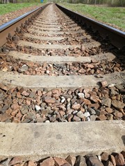 rails railroad parallel linear perspective sleepers crushed stone