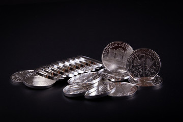 Investment silver fine bullion coins, secure means to preserve wealth during crisis. Physical silver coins on black background. Silver price market.