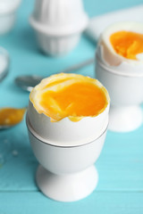 Soft boiled chicken egg served on light blue table